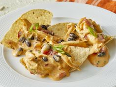 a white plate topped with nachos and tortilla chips