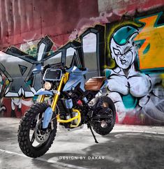 a motorcycle parked in front of a graffiti covered wall