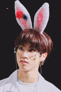 a young man wearing bunny ears and glasses