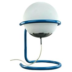 a blue and white lamp with a cord attached to the light on it's side