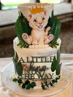 a cake decorated with leaves and a lion on top