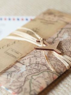 an old map with a wooden cross tied to it on top of a piece of paper