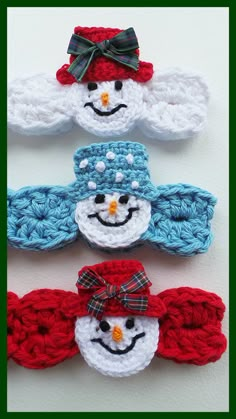 three crocheted snowmen with hats and bows