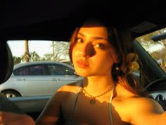 a woman sitting in the back seat of a car