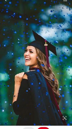 a woman in graduation cap and gown is smiling at the camera with rain falling on her