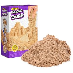 the sand is being made into a castle and it's in front of a cardboard box