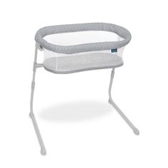 a grey and white baby bassinet on a white background