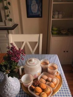 a plate with some food on it sitting on a table next to a potted plant