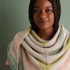 a woman with braids wearing a shawl