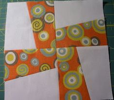 an orange and white patchwork piece with circles on it