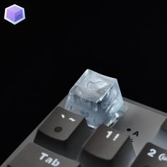 an ice cube sitting on top of a computer keyboard