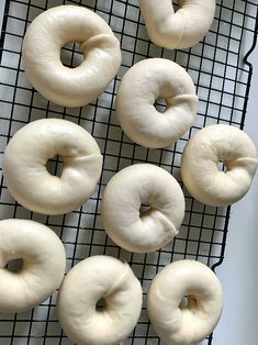 six doughnuts on a cooling rack ready to be baked in the oven for consumption