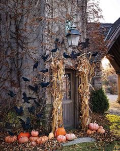 an old house with pumpkins and vines on the front