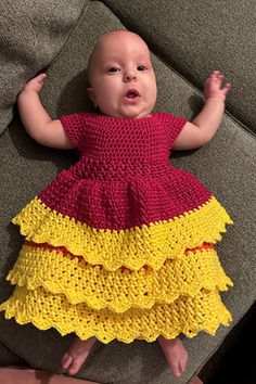 a baby is wearing a dress made out of crochet