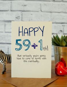 a birthday card with a zebra figurine next to it and a potted plant