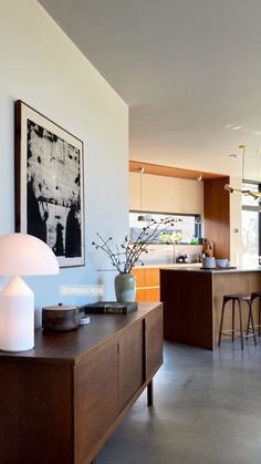 a modern kitchen with an island and bar stools