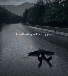 a person laying on the ground in the middle of a road with an overthiring will destroy you