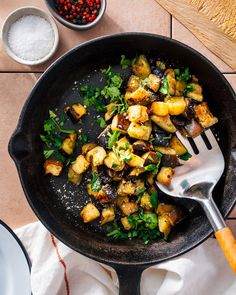 a skillet filled with cooked eggplant on top of a table