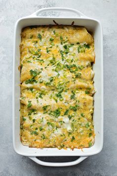 a casserole dish with cheese and vegetables in it on a gray surface, top view