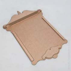 a piece of cardboard cut out to look like a place mat with an ornate border