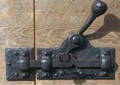 an old metal latch on a wooden door