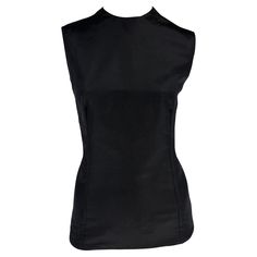 From the Spring/Summer 1990 collection, this Gianni Versace black silk sleeveless top is the perfect elevated essential. Approximate measurements: Size - 42IT Shoulder to hem: 24" Bust: 36" Waist: 32" 100% Silk Silk Sleeveless Tank Top For Work, Black Silk Sleeveless Tank Top, Fitted Silk Tank Top For Work, Formal Silk Tank Top For Summer, Sleeveless Silk Blouse For Night Out, Fitted Sleeveless Blouse Tank Top For Evening, Sleeveless Silk Blouse For Formal Occasions, Black Sleeveless Blouse For Formal Occasions, Fitted Silk Vest For Workwear