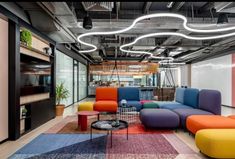 an office with multicolored couches and tables