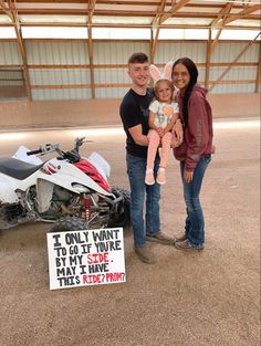 a man, woman and child standing in front of a motorcycle with a sign that says i only want to go if you are brave