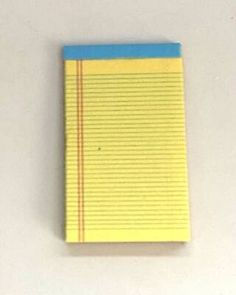 a yellow and blue notebook sitting on top of a white table