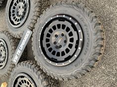 four tires are shown on the ground next to each other