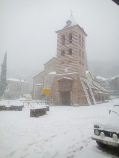 a car parked in front of a church on a snowy day