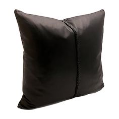 a black pillow on a white background with a cord in the middle and an end