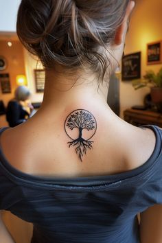 a woman with a tree tattoo on her back