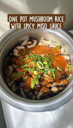 a bowl filled with mushrooms and sauce on top of a table