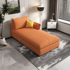 an orange chaise lounger in a living room with grey carpet and white walls