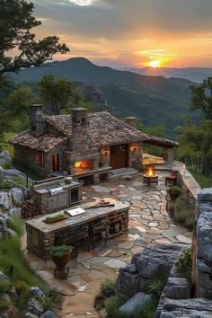 an outdoor kitchen and dining area in the mountains