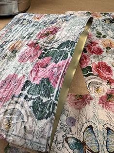 a table cloth with flowers and butterflies on it