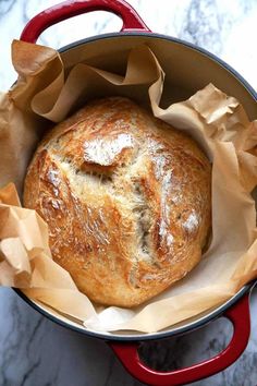 a loaf of bread sitting in a red pot