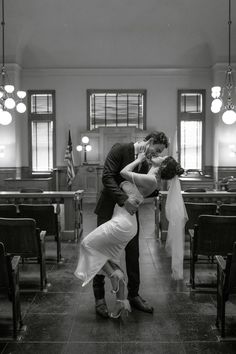 a bride and groom kissing in the church