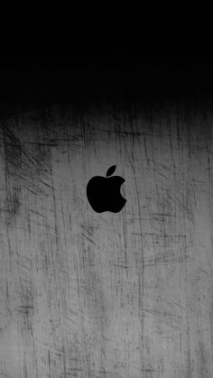 an apple logo is shown on the side of a concrete wall in black and white