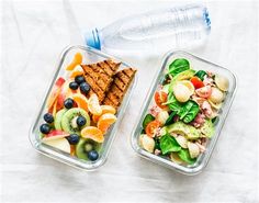 two plastic containers filled with food next to a water bottle