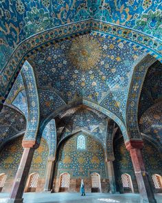 the inside of an ornate building with blue and gold paint on it's walls