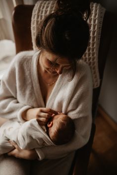 a woman holding a baby in her arms