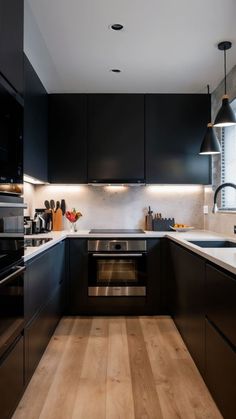 the kitchen is clean and ready for us to use it's dark wood floors