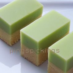 three pieces of green cake sitting on top of a white plate next to each other