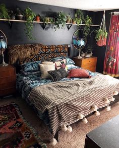 a bed room with a neatly made bed and lots of plants