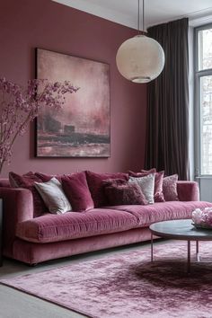 a living room filled with furniture and pink walls