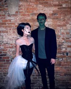 a man and woman dressed up in costumes standing next to each other with makeup on their faces