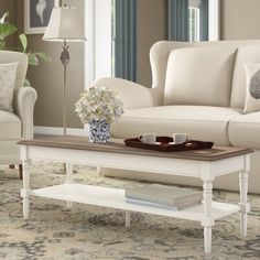 a coffee table with flowers on it in a living room