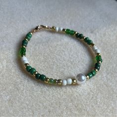 - One Of A Kind Beaded Bracelet - Featuring Green, White, And Gold Seed Beads With A White Pearl Bead At The Center - Gold Colored Hardware - Clasps Closed. No Stretch. - Size/ Circumference Is 7” - Handmade (By Myself). Perfect To Treat Yourself Or To Give As A Unique Gift! **Add 2 Jewelry Items Marked “2 For $20” To Your Bundle And I Will Send You An Offer For $20** Tags: Beaded, Handmade Jewelry, Colorblock Check Out The “Boutique” Tab In My Closet For Handmade Earrings, Bracelets, And Neckla Green And Blue Seed Bead Bracelet, Green Bead Bracelet Ideas, Green Bracelet Ideas, Small Bead Bracelet, Gold Beaded Bracelet, Bracelet Craft, Green Beaded Bracelets, Bracelets Ideas, Green Bracelet